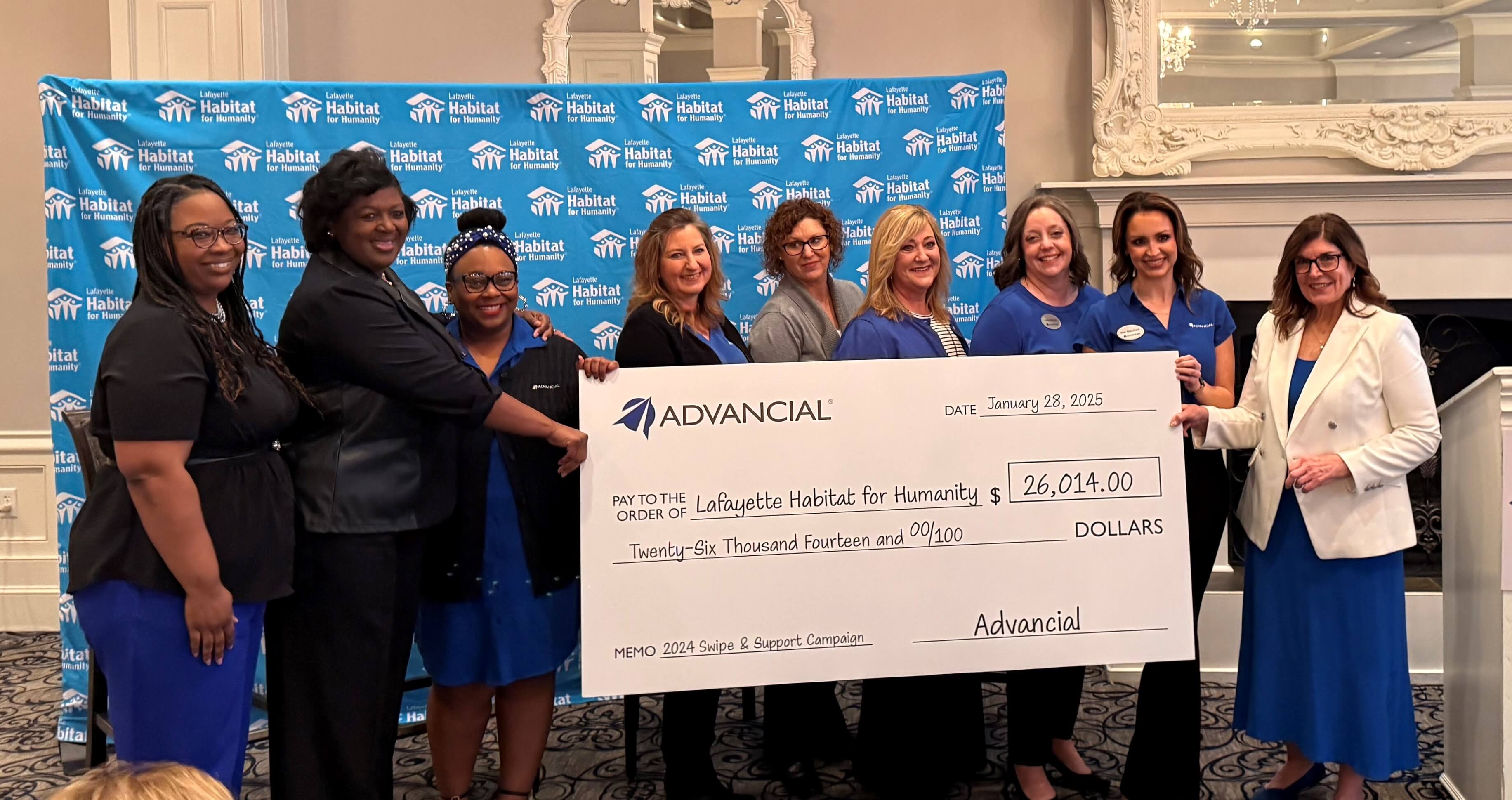 advancial employees presenting a giant check saying advancial members have raised $26,014 for lafayette habitat for humanity advancial employees presenting a giant check saying advancial members have raised $26,014 for lafayette habitat for humanity
