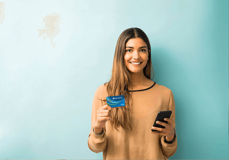 a woman smiling holding a Visa Rewards Plus credit card